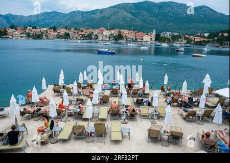Cavtat (Dubrovnik), Croatia, Crowd People, Tourists Relaxing on Lounge Chairs, Luxury Hotel Terrace by Adriatic Sea , Coastline, Beach Scenes, Landscapes, Umbrellas Stock Photo