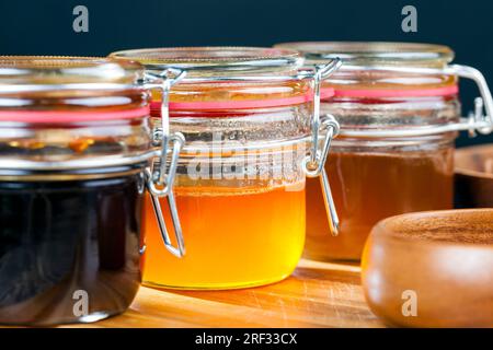 several varieties of flower honey from different varieties of flowers, bottled in different cans several types of honey that differ in color and taste Stock Photo