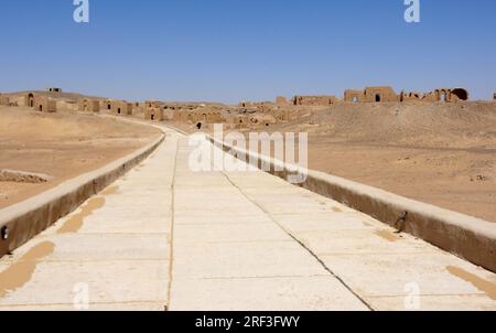 road and distant ruinsin the Libyan Desert in Egypt Stock Photo