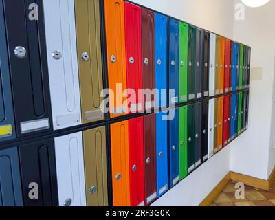 Close-up group of colorful mail boxes in apartment building Stock Photo