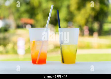 Orange cocktail Spritz and lemonade, refreshing summer drinks on the terrace in the park. Stock Photo