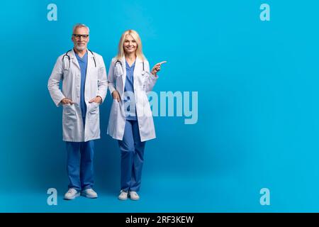 Horizontal full length shot of cheerful senior doctors, copy space Stock Photo