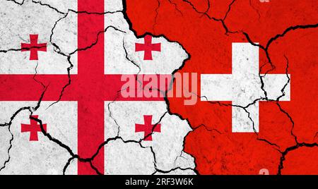 Flags of Georgia and Switzerland on cracked surface - politics, relationship concept Stock Photo