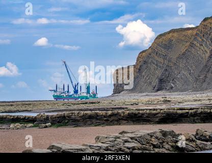 Platform rig with cranes off the Jurassic coast of Somerset at Hinkley Point during the building of HPC nuclear power station Stock Photo