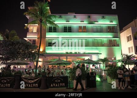 Miami, Florida USA - April 16, 2021: Miami south beach ocean drive illuminated buildings in night miami city with cafe. Stock Photo