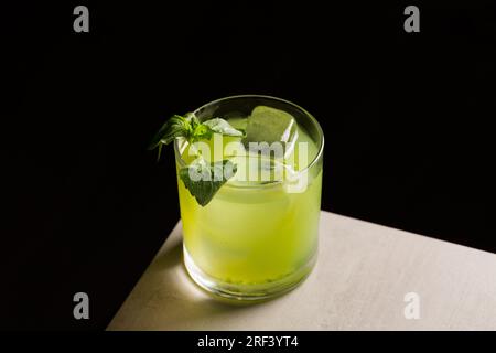 Gin Basil Smash Cocktail booze gin, lemon juice, syrup and basil leaves Stock Photo