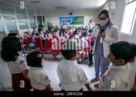 A doctor provides health education to elementary school students who visit the Vania Bogor hospital, Indonesia Stock Photo