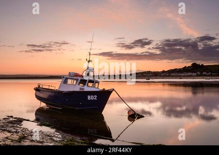 Summer sunrise over the North Devon coastal villages of Instow and Appledore as a colourful dawn sky lights up the outgoing tide on the River Torridge Stock Photo