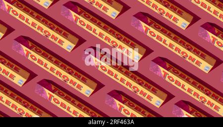 Toblerone pattern. Swiss chocolate with raising almond nougat. New package mountain logo on pink background. Candy sweets are a classic souvenir of Switzerland, Mondelez. Kyiv, Ukraine - July 10, 2023 Stock Photo