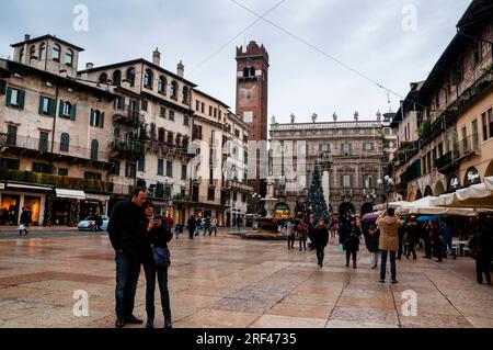 Gardello Tower and Fontana Madonna in Piazza delle Erbe, Verona, Italy Stock Photo