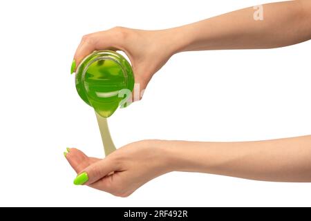 Green slime toy in woman hand with green nails isolated on a white background. Stock Photo