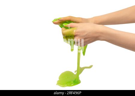Green slime toy in woman hand with green nails isolated on a white background. Stock Photo