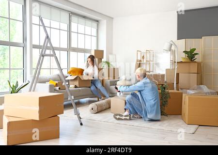 Young couple packing things in room on moving day Stock Photo