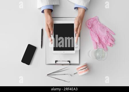 Doctor working with tablet computer on white table Stock Photo