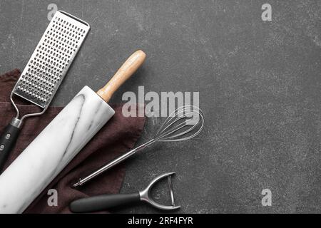 Set of different kitchen utensils on dark background Stock Photo