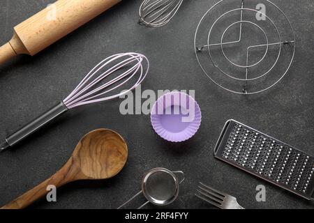 Set of different kitchen utensils on dark background Stock Photo