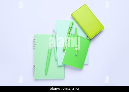 Composition with different notebooks, pens and markers on white background Stock Photo
