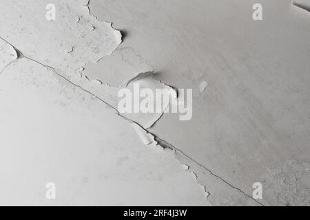 Shabby rotting ceiling. The paint is peeling off close up Stock Photo