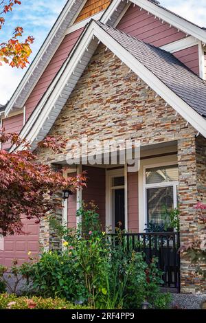 Entrance to a home through a beautiful garden with colorful flowers. Plants and flowers on a doorstep leading to entrance of a house. Front of a house Stock Photo