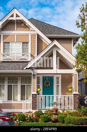 Entrance to a home through a beautiful garden with colorful flowers. Plants and flowers on a doorstep leading to entrance of a house. Front of a house Stock Photo