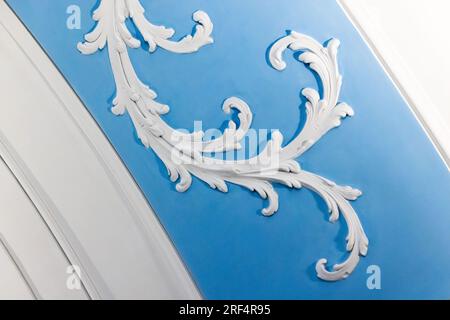 White bas-relief over blue background, wall design gypsum details in rococo style, classic architecture template Stock Photo