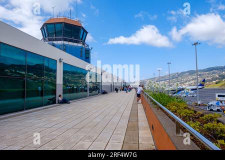 Airport travel, passengers outside watching the runway planes at Madeira Airport, control tower, Madeira Island archipelago, Funchal, Portugal Stock Photo