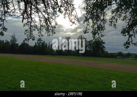 Sun peaks throug rain clouds Stock Photo