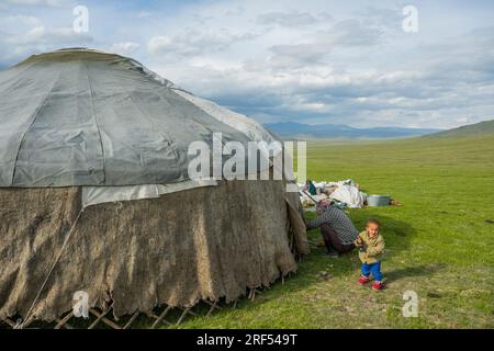 A Kazakh herder family is erecting a ger in a remote valley in the Altai Mountains (Altay Mountains) near Altai Sum about 200 kilometers from Ulgii (Ö Stock Photo