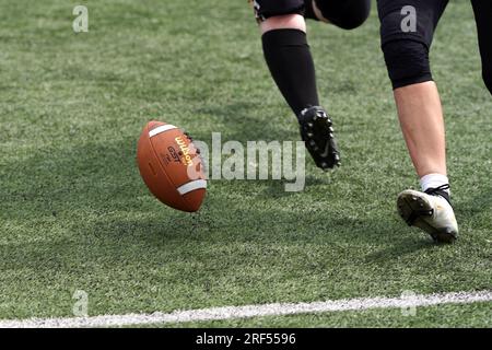 Chasing a bouncing American Football Stock Photo