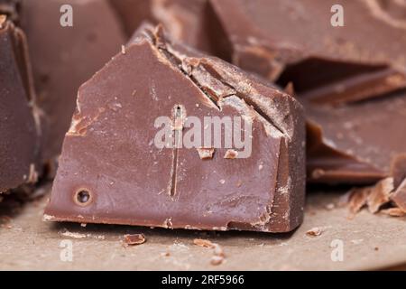 broken into several parts pieces of chocolate from cocoa, natural food from cocoa, sugar, cocoa butter, pieces of large natural real chocolate Stock Photo