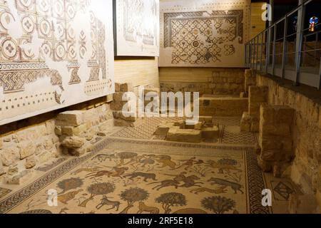 An ancient mosaic inside a Christian church, a lion, a donkey, a goat, a deer, a tree, and a knight on a horse (Mount Nebo, Madaba, Jordan) Stock Photo
