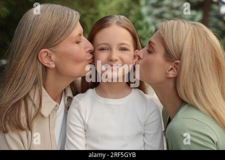 Three generations. Happy grandmother, her daughter and granddaughter outdoors Stock Photo