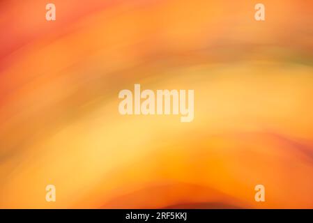 Artistic abstract warm background in vivid orange and yellow colors. Smooth and flowing design, energetic and vibrant. Stock Photo