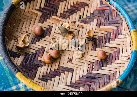 Macadamia nuts crashed on the weaved-open basket in Nairobi City County Kenya East Africa Farm Farming Stock Photo