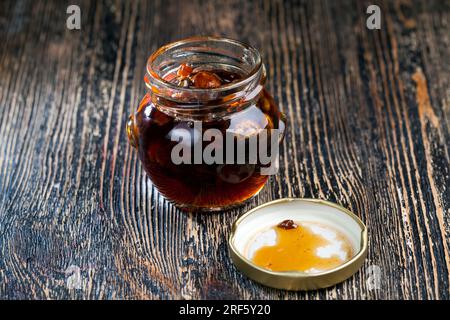 natural viscous honey with nuts, which is produced by honey bees, honey is packaged and used in food because it contains a large amount of carbohydrat Stock Photo