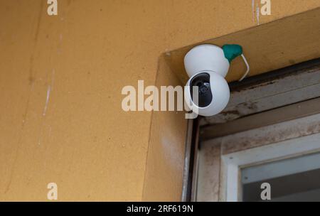 Security Camera, CCTV on location. Security camera on the wall in old city. Stock Photo