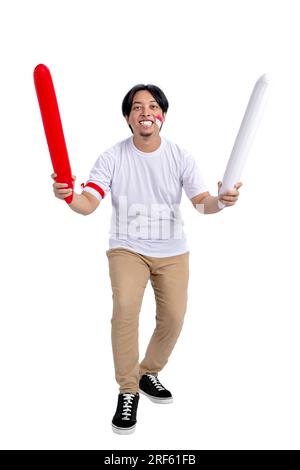 Indonesian man supporting Indonesian team when competing isolated over white background Stock Photo