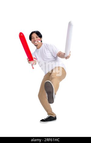 Indonesian man supporting Indonesian team when competing isolated over white background Stock Photo