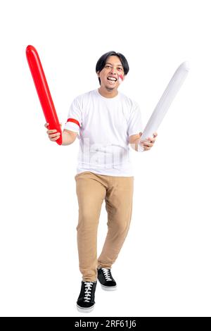 Indonesian man supporting Indonesian team when competing isolated over white background Stock Photo