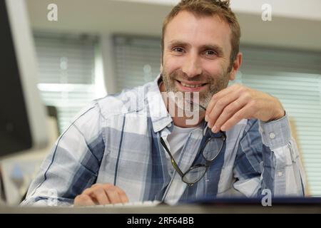 businessmanager wearing casual clothes smiling happily at camera Stock Photo