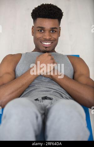 muscular builder man does sit-ups Stock Photo