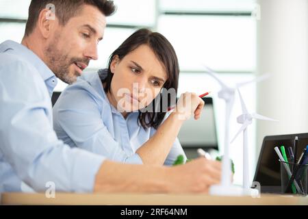 architects studying plans in modern office together Stock Photo