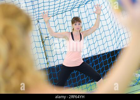 female handball athlete trying to stop player from marking Stock Photo
