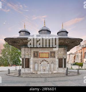 Fountain of Sultan Ahmed III, aka Ahmet Cesmesi, a 17th century public Turkish rococo water fountain, or Sabil, located in the Great Square, near the Imperial Gate of Topkapi Palace, Istanbul, Turkey Stock Photo