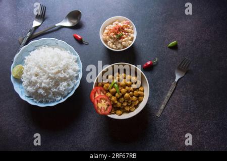 Top view of Indian lunch menu chickpea masala and rice. Stock Photo
