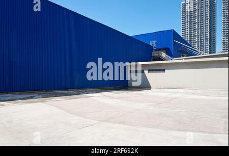 Minimalist composition of dark blue iron wall and concrete floor urban background Stock Photo