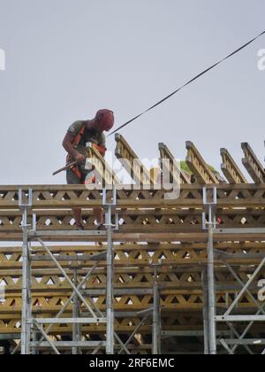 Workers work in site for the new sport future city of Milan, Lombardy, Italy Stock Photo