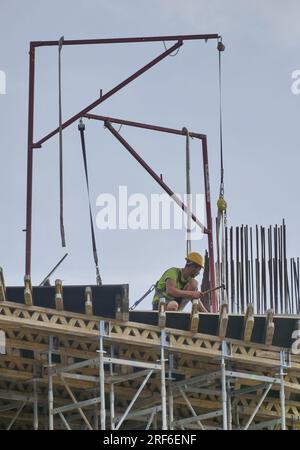 Workers work in site for the new sport future city of Milan, Lombardy, Italy Stock Photo