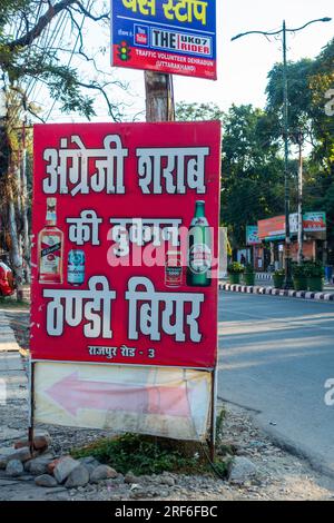 June 28th 2023.Dehradun city, Uttarakhand India. Colourful Liquor Store' signboard in Hindi on the roadside. Stock Photo