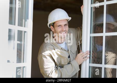 portrait of contractor working on double glazed windows Stock Photo